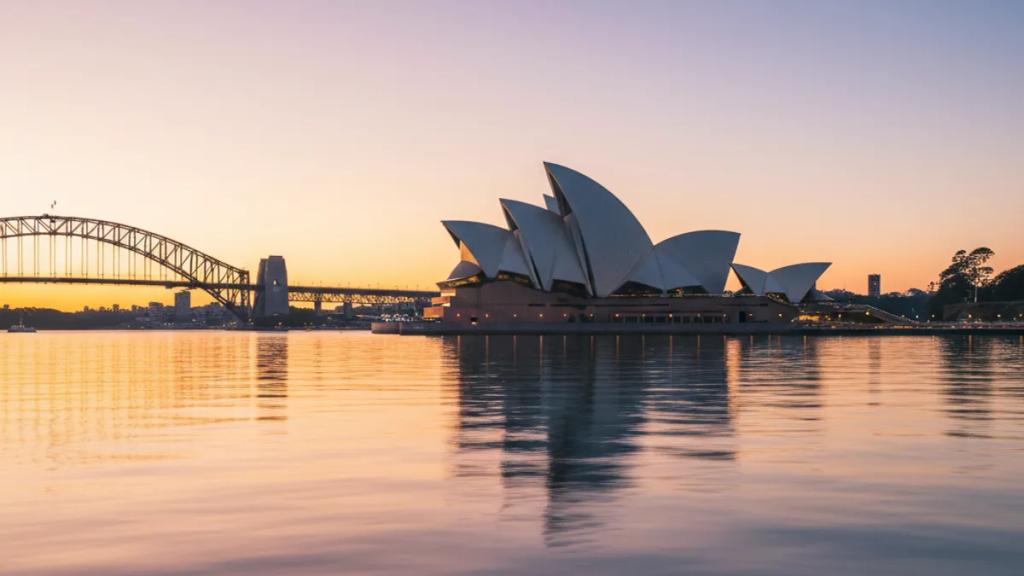 Traveller at Sydney Harbour at dusk checking whether their phone has signal