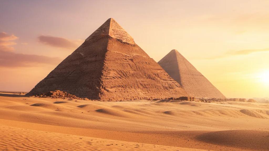 Traveller near the Giza pyramids at golden hour checking whether their phone has signal