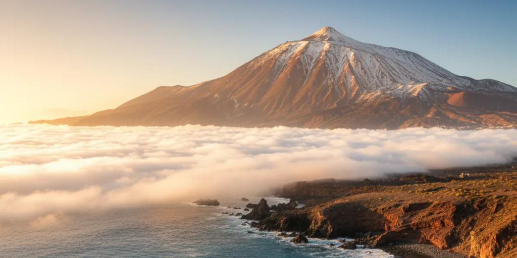Mount Teide rising above the clouds and the Tenerife coastline